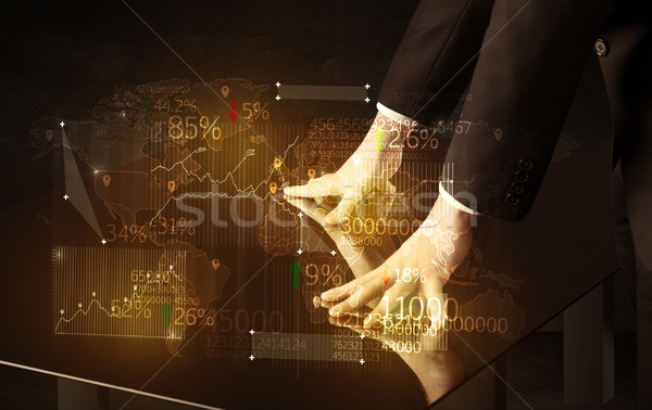Hands navigate on high tech smart table with business icons Stock photo © ra2studio