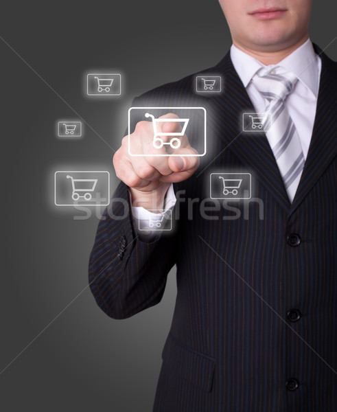 Man pressing shopping cart icon Stock photo © ra2studio