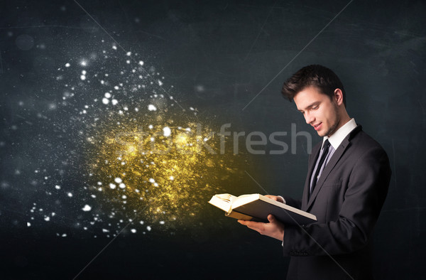 Young guy reading a magical book Stock photo © ra2studio