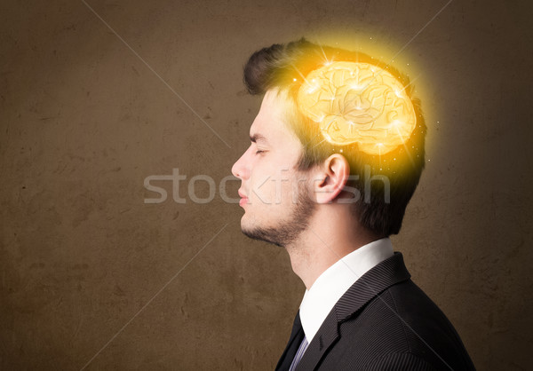 Young man thinking with glowing brain illustration Stock photo © ra2studio