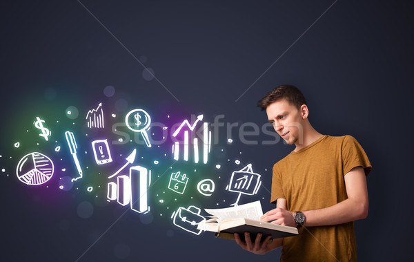 Young guy reading a book with business icons Stock photo © ra2studio
