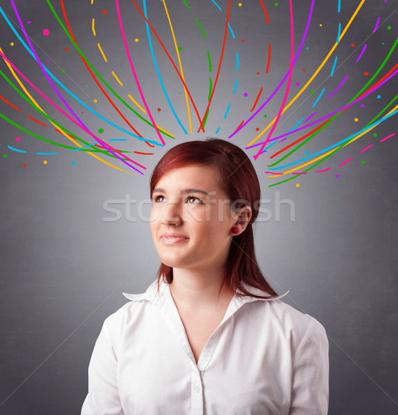 Young girl thinking with colorful abstract lines overhead Stock photo © ra2studio