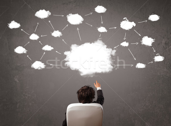 Businessman sitting with cloud technology above his head Stock photo © ra2studio