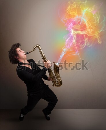 Attractive musician playing on saxophone with colorful abstract  Stock photo © ra2studio