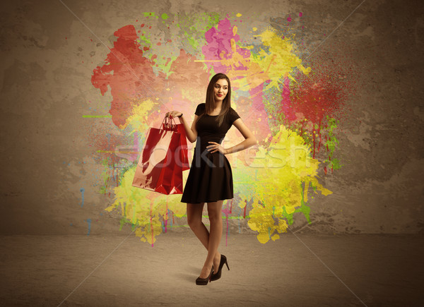 Girl with shopping bags and paint splatter Stock photo © ra2studio