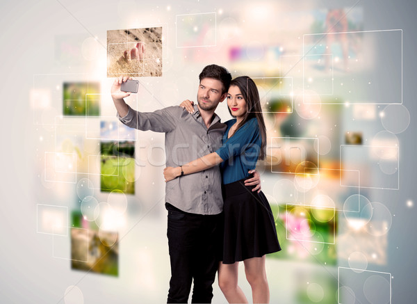 Stock photo: Happy young couple taking selfie pictures