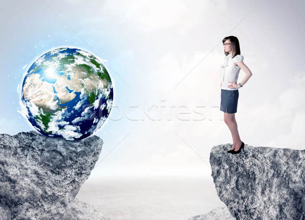 Businesswoman on rock mountain with a globe Stock photo © ra2studio