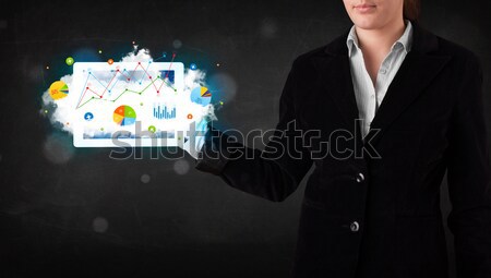 Person holding a touchpad with cloud technology and charts Stock photo © ra2studio