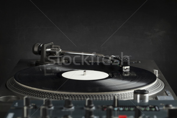 Stock photo: Turntable playing vinyl close up with needle on the record 