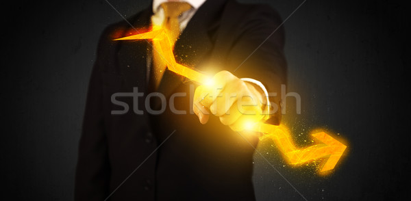 Business person holding a hot glowing upright arrow Stock photo © ra2studio