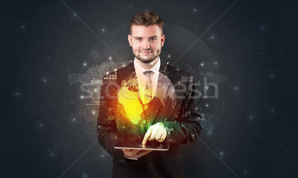 Spectacled businessman with tablet and apps above Stock photo © ra2studio