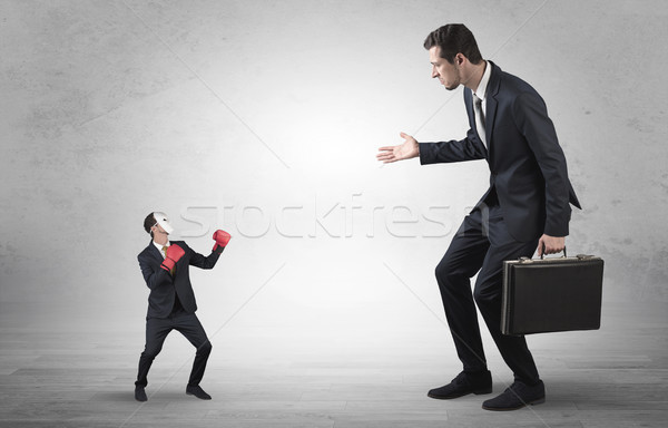 Businessman begging for small masked businessman Stock photo © ra2studio