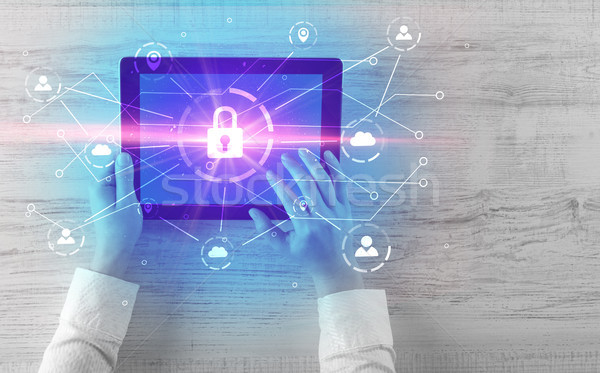 Hand using tablet with network security and online storage system concept Stock photo © ra2studio