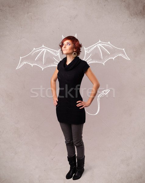 Young girl with devil horns and wings drawing Stock photo © ra2studio