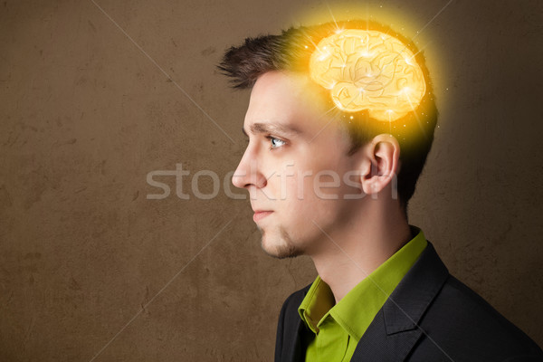 Young man thinking with glowing brain illustration Stock photo © ra2studio