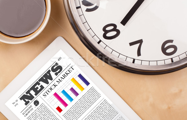 Tablet pc shows news on screen with a cup of coffee on a desk Stock photo © ra2studio