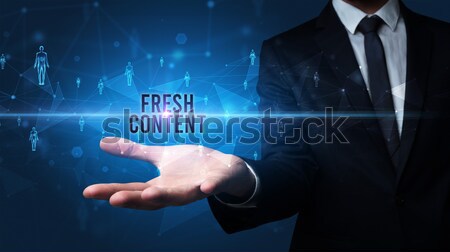 Young businessman holding a tablet with modern software operational system Stock photo © ra2studio