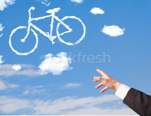 Stockfoto: Hand · wijzend · fiets · wolken · blauwe · hemel · jonge