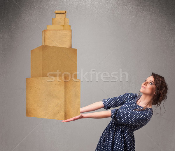 Young lady holding a set of brown cardboard boxes Stock photo © ra2studio