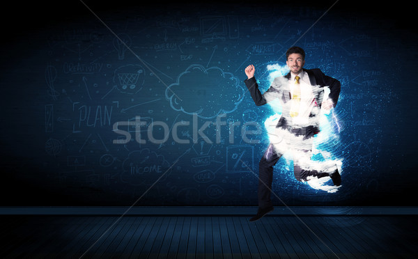 Happy business man jumping with storm cloud around him  Stock photo © ra2studio