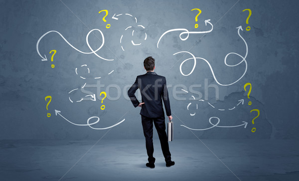 Unsure businessman with question marks Stock photo © ra2studio