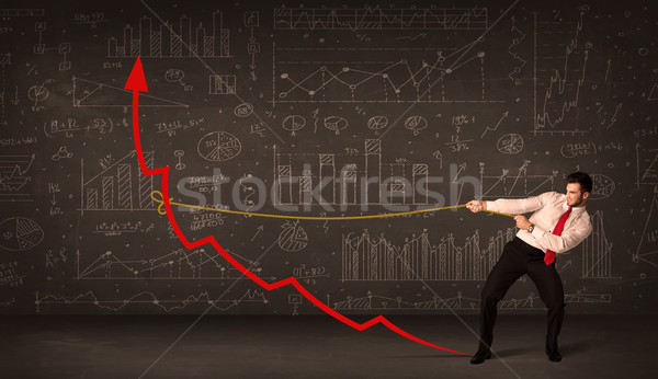 Businessman pulling a red arrow upright with a rope  Stock photo © ra2studio