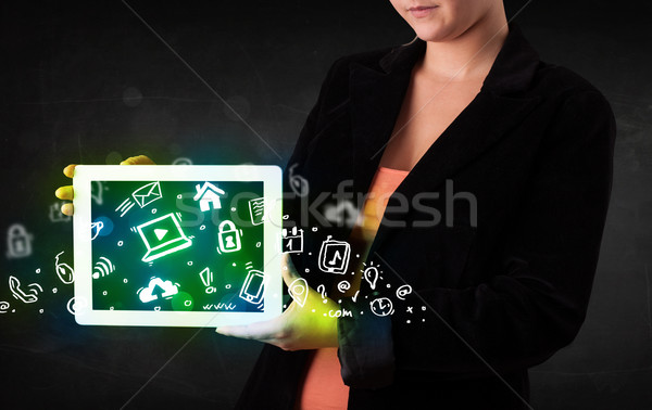 Person holding tablet with green media icons and symbols Stock photo © ra2studio