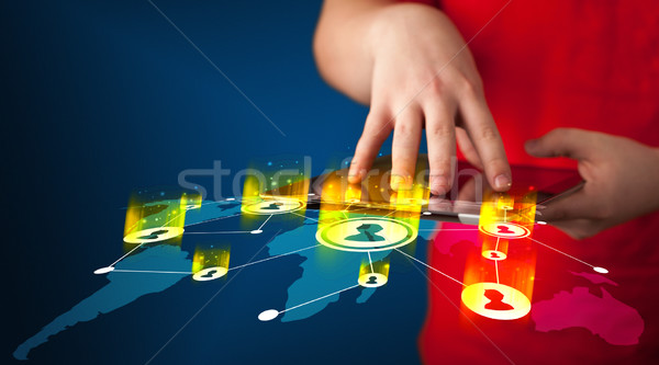 Hand holding tablet device with social network map Stock photo © ra2studio