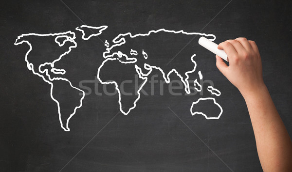 Adult drawing world map on chalkboard Stock photo © ra2studio