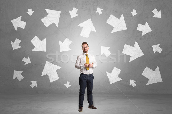 Businessman standing with arrows around Stock photo © ra2studio