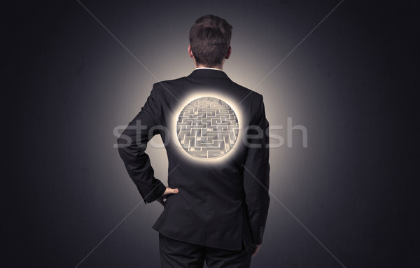 Stock photo: Businessman standing with maze on his back