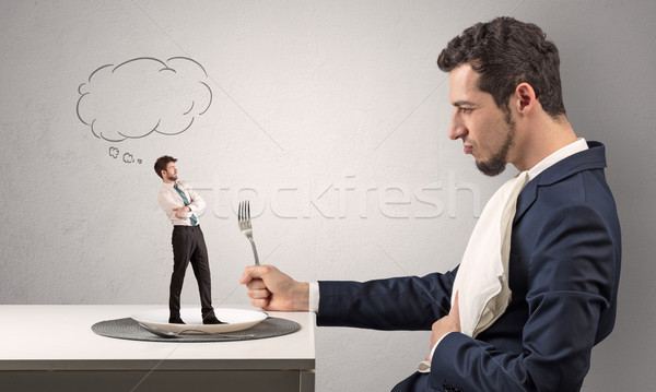 Businessman want to eat small man  Stock photo © ra2studio