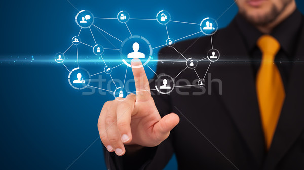 Businessman pressing modern social type of icons Stock photo © ra2studio