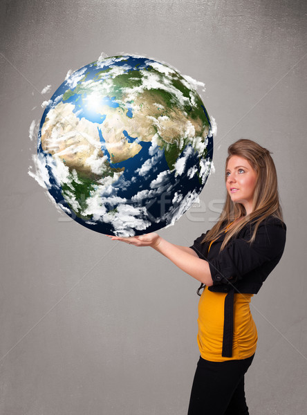 Pretty girl holding 3d planet earth Stock photo © ra2studio