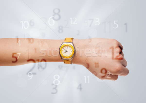 Hand with watch and numbers on the side comming out Stock photo © ra2studio