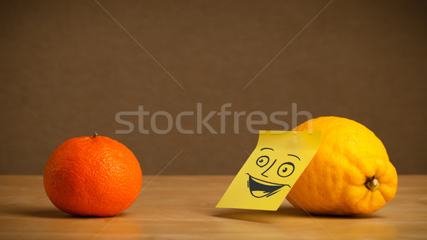 Lemon with post-it note smiling at orange Stock photo © ra2studio