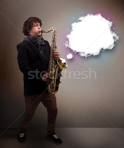 Young man playing on saxophone with copy space in white cloud Stock photo © ra2studio