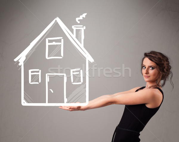 Young lady holding a huge drawn house Stock photo © ra2studio