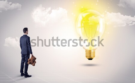 Businesswoman on rock mountain with idea bulb Stock photo © ra2studio