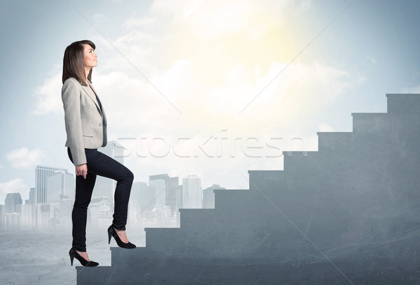 Businesswoman climbing up a concrete staircase concept Stock photo © ra2studio