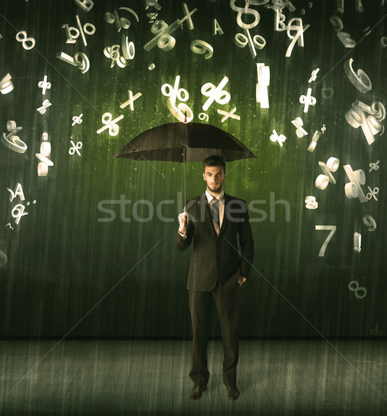 Businessman standing with umbrella and 3d numbers raining concep Stock photo © ra2studio