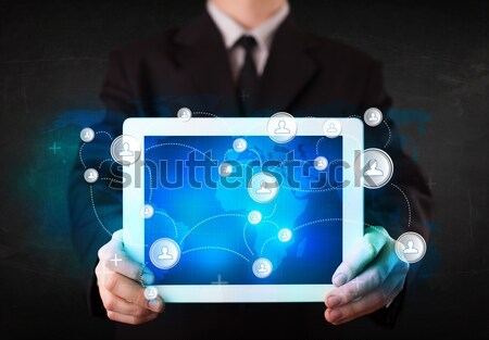 Young person holding talbet with communication technology concep Stock photo © ra2studio