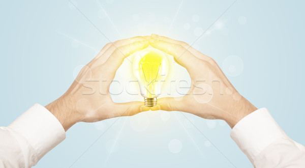 Hands creating a form with light bulb Stock photo © ra2studio
