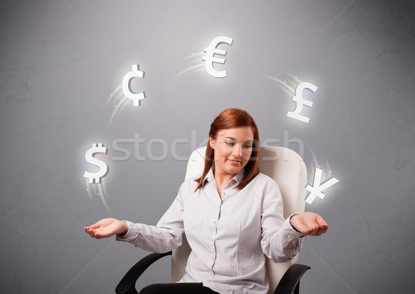  young lady sitting and juggling with currency icons Stock photo © ra2studio