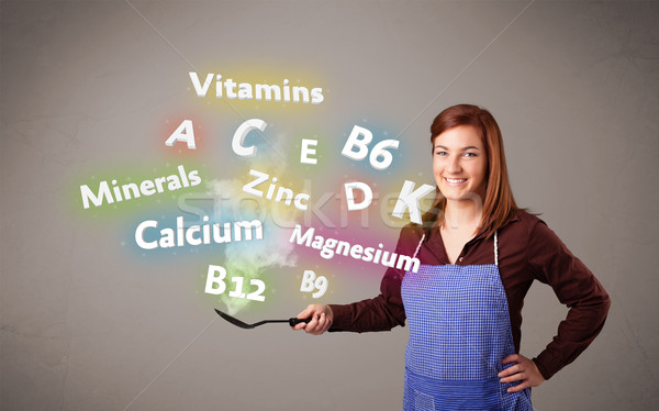 Young woman cooking vitamins and minerals Stock photo © ra2studio