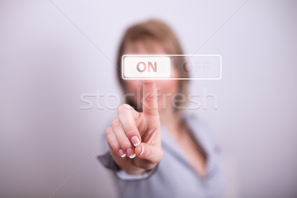 Woman pressing on off button Stock photo © ra2studio