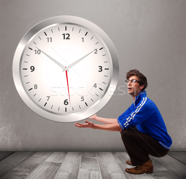 Attractive boy holding a huge clock Stock photo © ra2studio