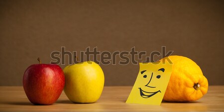 Lemon with post-it note sticking out tongue to apples Stock photo © ra2studio