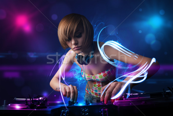 диск-жокей играет музыку световыми эффектами фары красивой Сток-фото © ra2studio