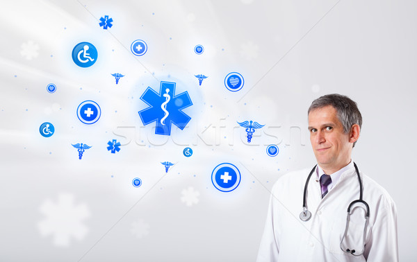 Doctor with blue medical icons Stock photo © ra2studio